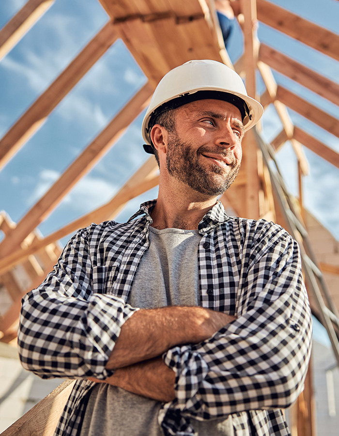 builder smiling when a new roof is being installed above him in hertfordshire